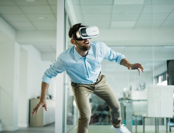 A man wearing a vr headset in an office. | The White Leaf 